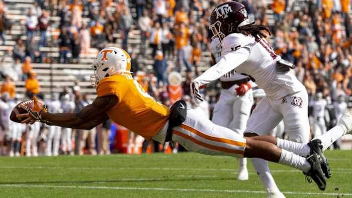 Former Tennesseee wide receiver Cedric Tillman dives forward against a Texas A&M defender at Neyland Stadium in Knoxville, Tenn.
